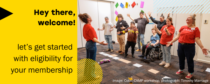 The banner graphic reads "hey there. welcome! Let's get started with eligibility for your membership." The image in the banner shows a group of people in colourful t-shirts participating in a workshop. They are smiling with their hands in the air.